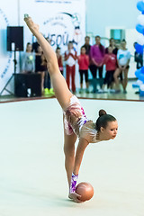 Image showing Young attractive girl shows exercise with ball