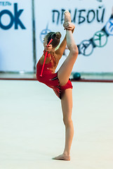 Image showing Young attractive girl shows exercise with maces