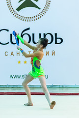 Image showing Young beautiful girl shows exercise with maces