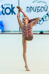 Image showing Young pretty girl shows exercise with ball