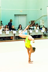 Image showing Young girl shows exercise with ball to judges