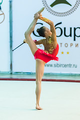 Image showing Young attractive girl shows exercise with maces