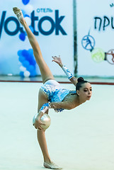 Image showing Young attractive girl shows exercise with ball