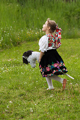Image showing Little girl playing on a meadow