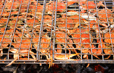 Image showing Grilled crab on flaming grill.