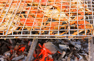 Image showing Grilled crab on flaming grill.