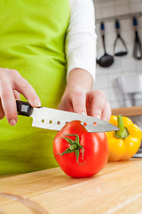 Image showing Woman\'s hands cutting tomato