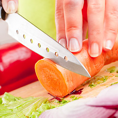 Image showing Woman\'s hands cutting vegetables