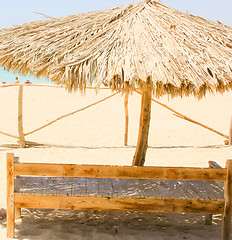 Image showing Wooden Chair and Natural Umbrella