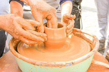 Image showing Hands working on pottery wheel. 