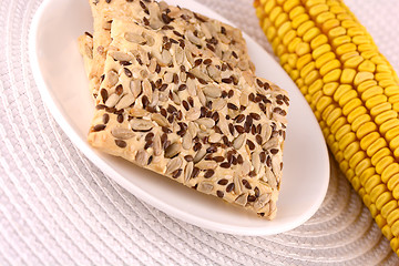Image showing sweet cake on white plate and corn