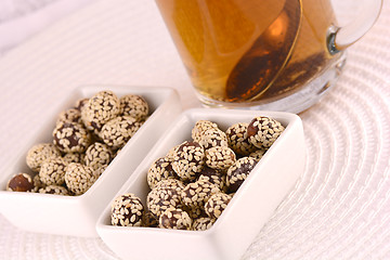 Image showing hot cup of tea and some cookies