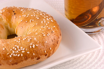 Image showing cup of tea and some cookies on white material background