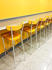 Image showing Bright cafeteria with a raw of chairs