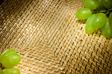 Image showing Wicker texture with green grapes on the corners