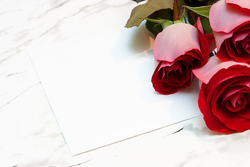 Image showing roses and a blank sheet of paper on a marble surface