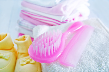 Image showing hairs brushes and baby clothes