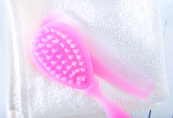 Image showing hairs brushes and baby clothes