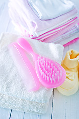 Image showing hairs brushes and baby clothes