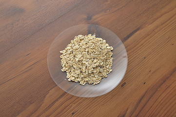 Image showing Plate of glass with oat flakes