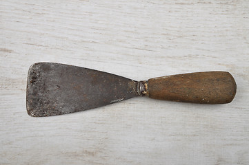 Image showing Putty knife on wood