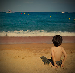 Image showing boy on the beach watching at the sea