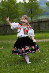 Image showing Little girl in traditional costume with flowers
