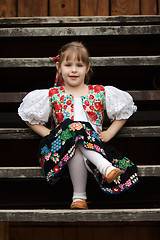 Image showing Sitting little girl in traditional costume