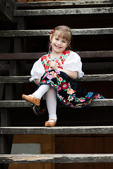 Image showing Sitting little girl in traditional costume