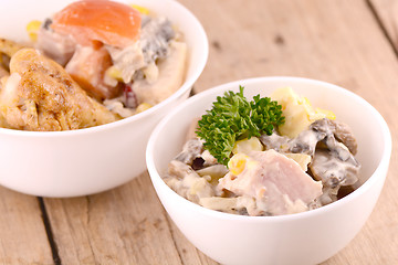 Image showing Fresh salad on white bowl and chicken legs