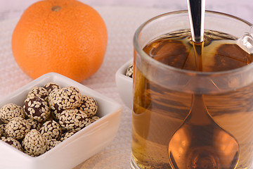 Image showing hot cup of tea and some cookies