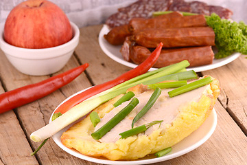 Image showing fresh salad with chicken chop and sausages on white plate