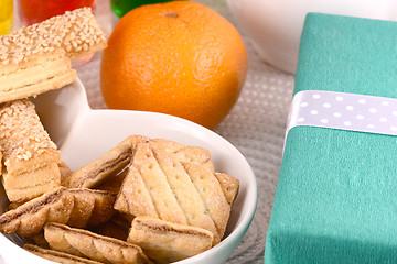 Image showing sweet cake on white plate, gift box, fruits and juice