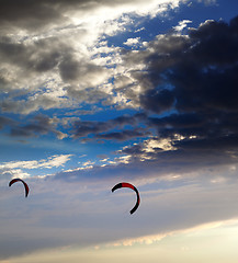 Image showing Two silhouette of power kites at sunset sky