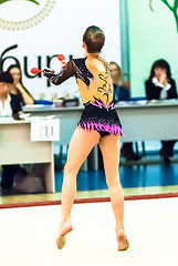 Image showing Young beautiful girl shows exercise with maces