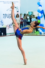 Image showing Young pretty girl shows exercise with ball