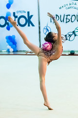 Image showing Young pretty girl shows exercise with ball