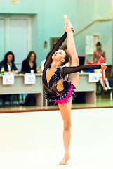 Image showing Young girl shows exercise with maces to judges