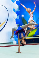 Image showing Young pretty girl shows exercise with ball