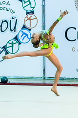 Image showing Young beautiful girl shows exercise with maces