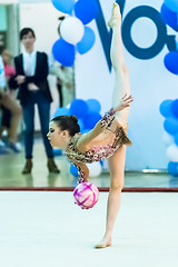 Image showing Young pretty girl shows exercise with ball