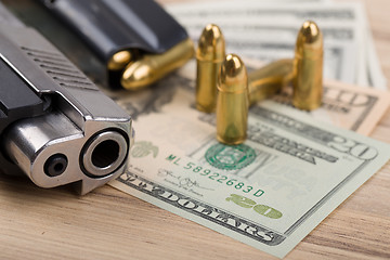 Image showing gun with bullet on US dollar banknotes