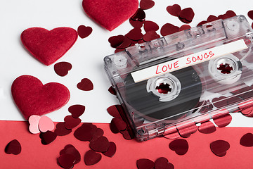 Image showing Audio cassette tape on red backgound with fabric heart