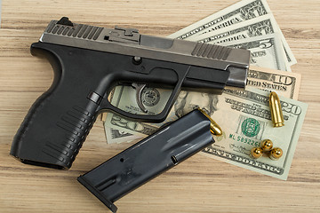 Image showing gun with bullet on US dollar banknotes