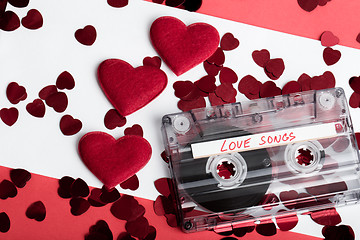 Image showing Audio cassette tape on red backgound with fabric heart