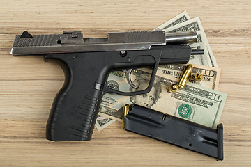 Image showing gun with bullet on US dollar banknotes