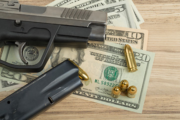 Image showing gun with bullet on US dollar banknotes