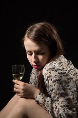 Image showing beautiful young brunette woman holding a glass of white wine