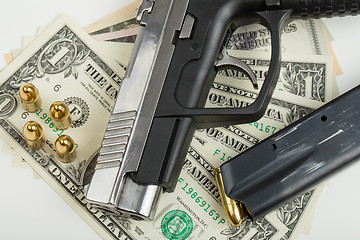 Image showing gun with bullet on US dollar banknotes