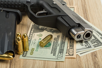 Image showing gun with bullet on US dollar banknotes